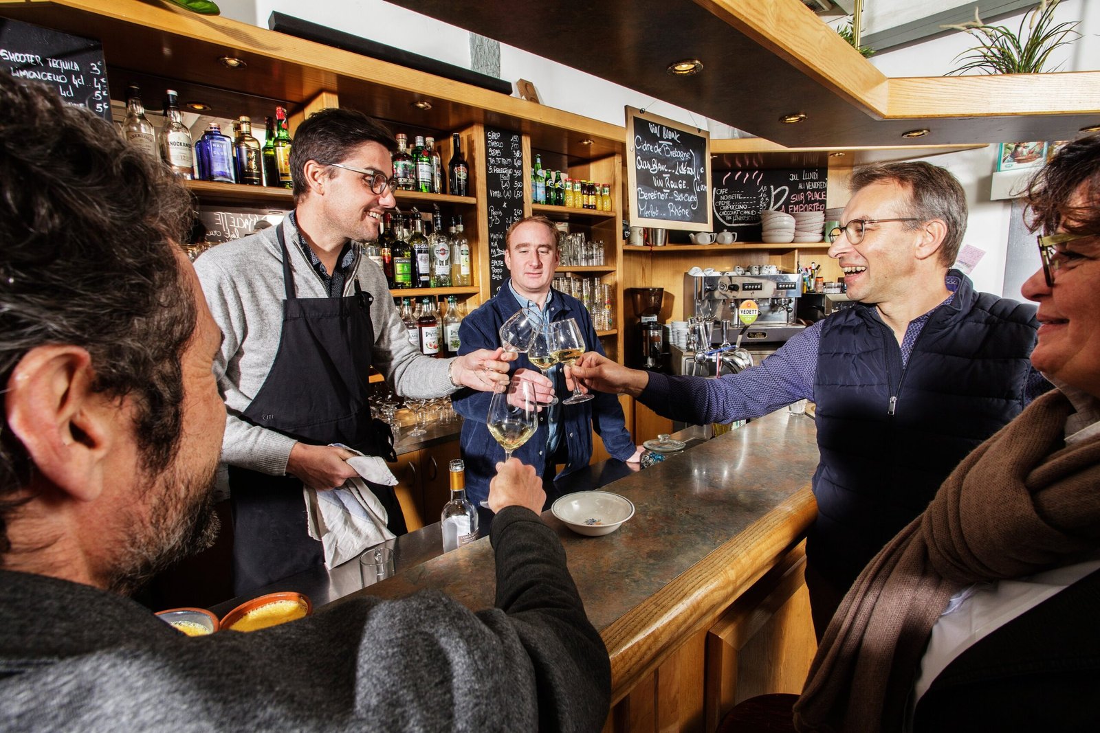 a group of people standing around a bar