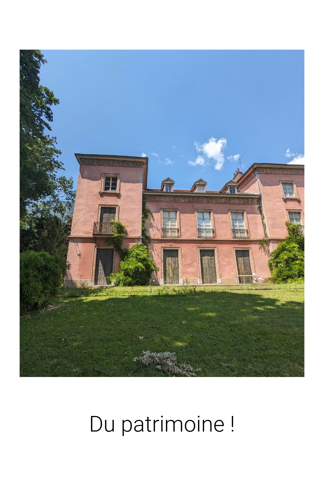 a large pink building with a sky background