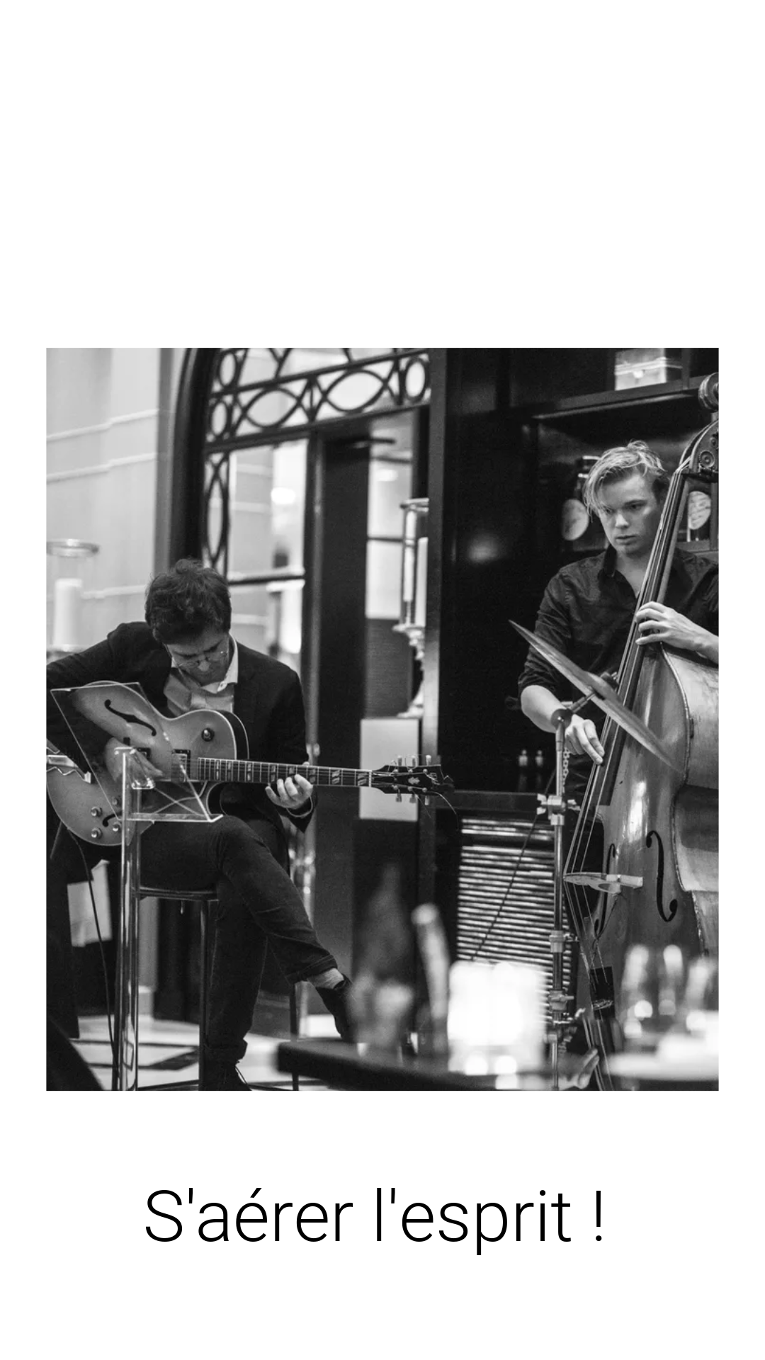 a man playing guitar in a cafe